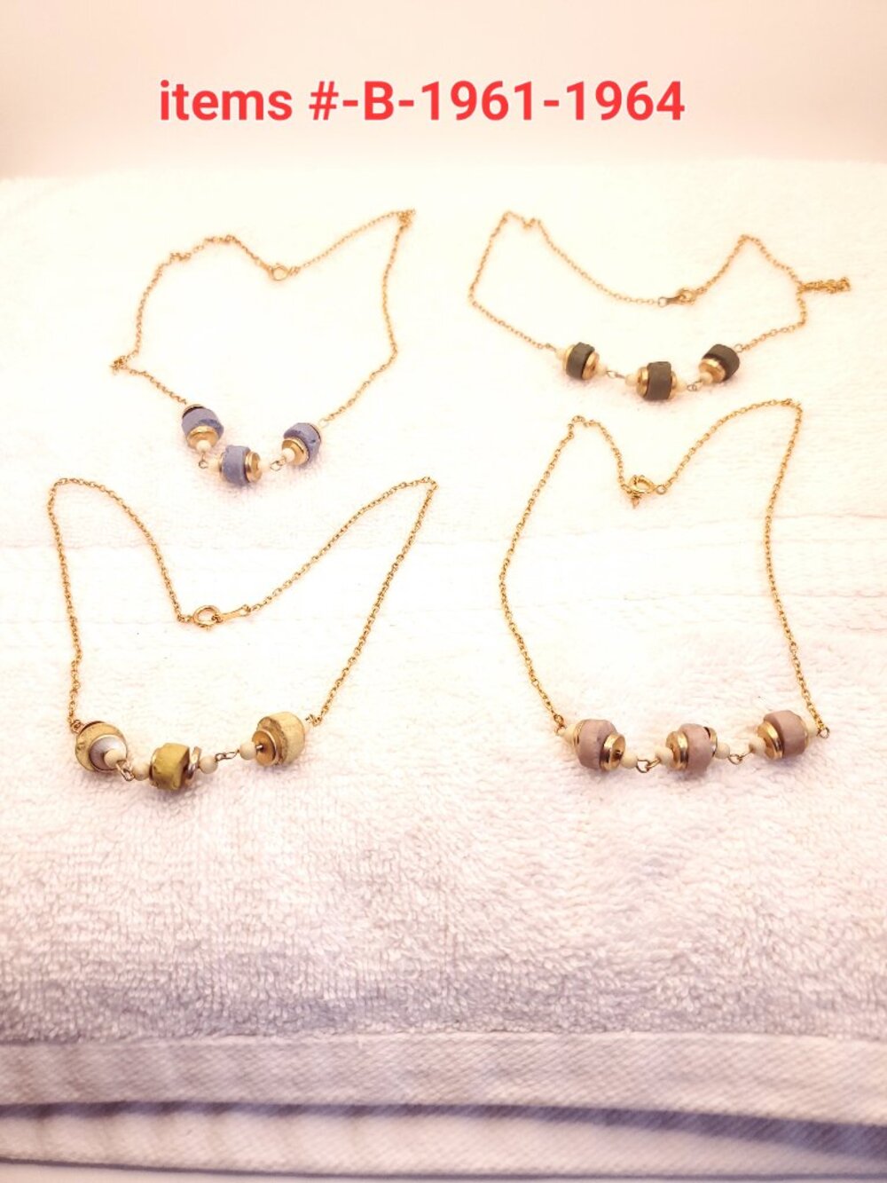 4 Necklaces w/ design pendants, items # B -1961-1964, wt. 29 grams.